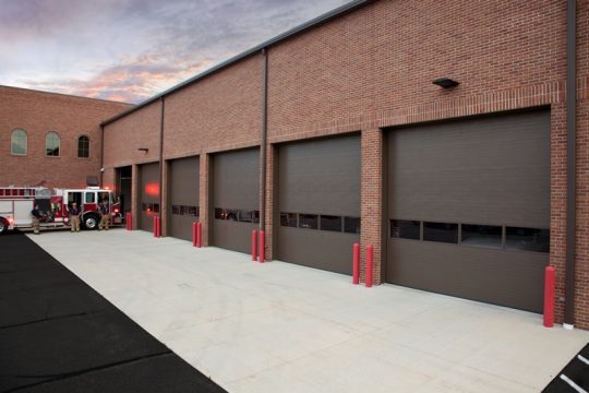 A row of bronze commercial garage doors.